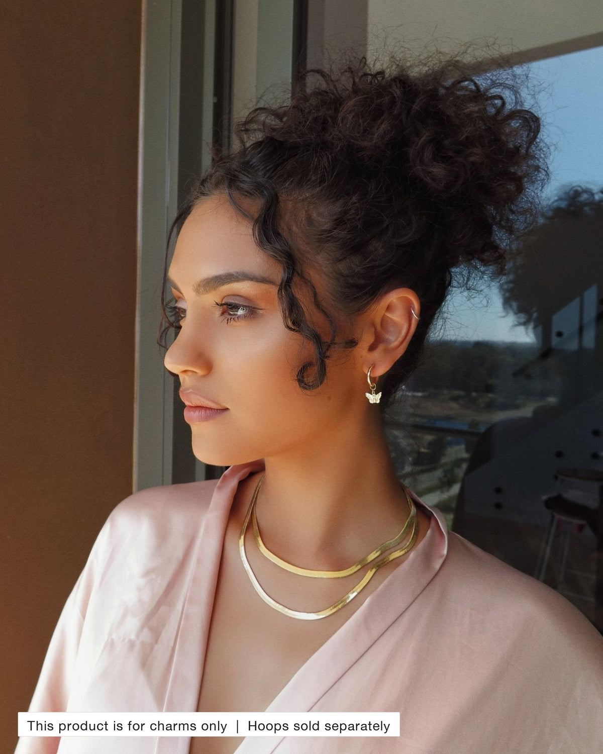 Model wearing Butterfly Hoop Earring Charms on gold Thick Hoop Earrings | The Littl