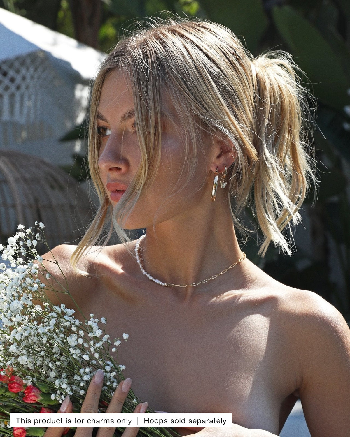 Model wearing gold Thick Hoop Earrings with Butterfly Hoop Earring Charms | The Littl