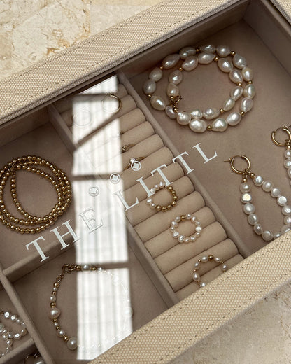 Sunlight across the Deluxe Jewellery Box, pearls and gold beads in the compartments | The Littl
