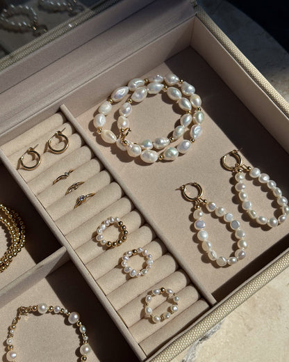 Pearl rings, bracelets and gold hoops resting inside the Deluxe Jewellery Box | The Littl